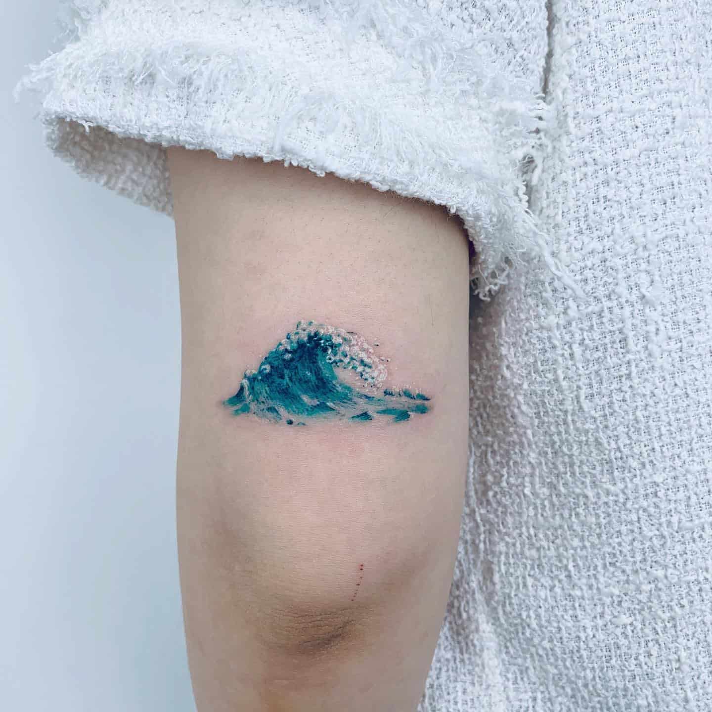 Blue Watercolor Wave Tattoo on Back of Arm