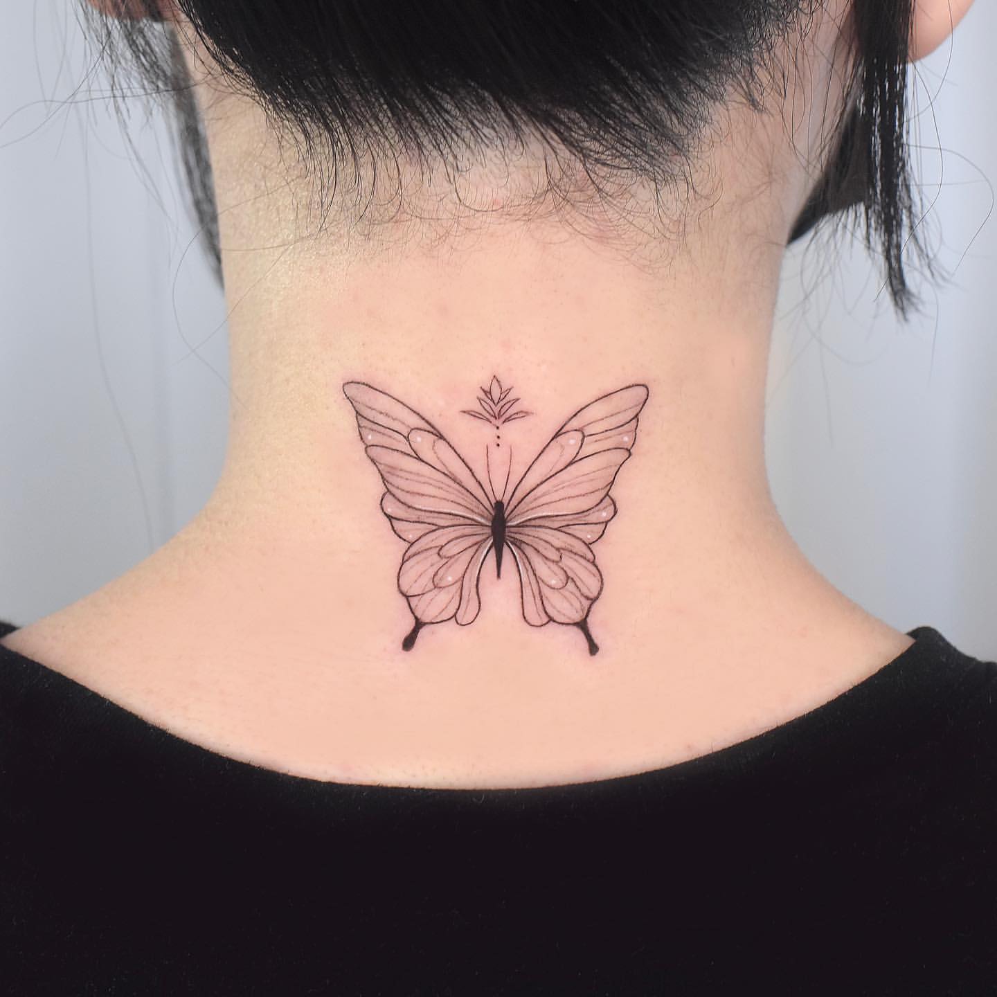 Cool butterfly tattoo on back of neck