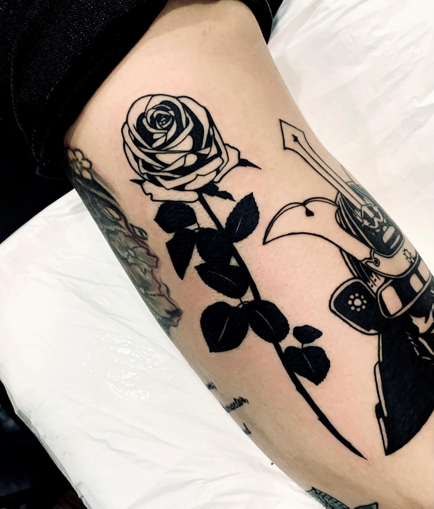 Black rose tattoo on the right thigh