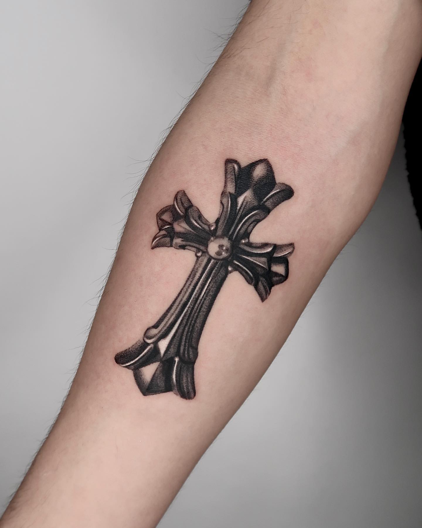Simple Black Cross Tattoo Design on inner Forearm